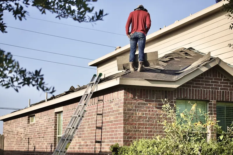 Professional roofer working on a residential roof in Manchester